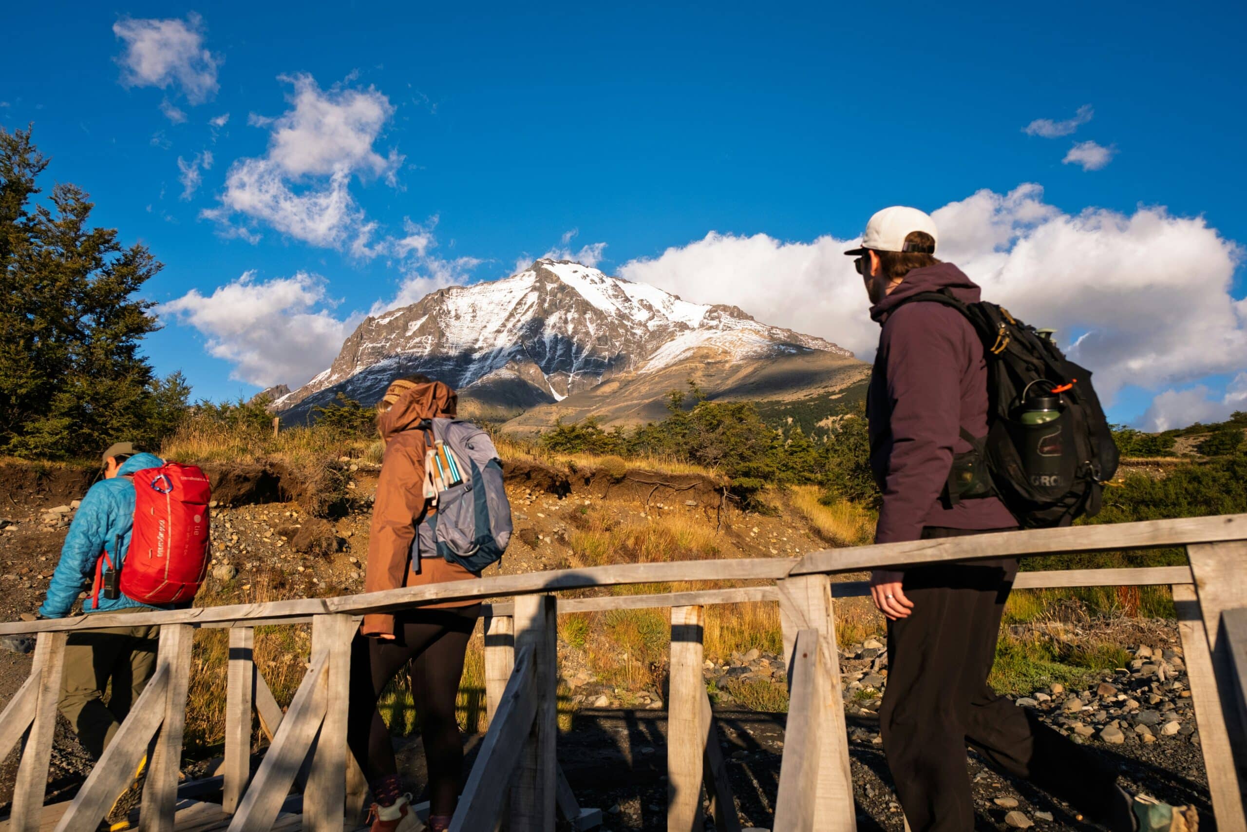 People crossing bridge in Patagonia, charity auction travel packages, vacation fundraising, travel fundraising, fundraising ideas, charity ideas, silent auction items, travel fundraising events